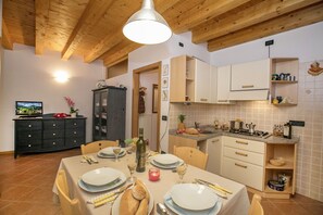 The living room with dinner table and view of the kitchen