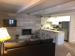 Living area with wood burning fireplace.