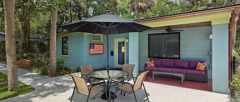 The lovely home offers a four person outdoor dining area and comfy couch.