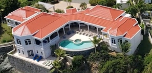 Covered deck and dining table by pool, while listing to music or just the waves.