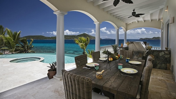 Outdoor dining by pool with a totally private view and access to ocean.