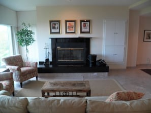 Living room with wood burning fireplace.