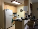 Kitchen with bar and new refrigerator, dishwasher and stove