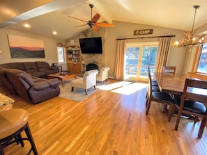 Living/Dining Area: Beautiful open concept space with large dining table that seats 10 and modern, comfortable furniture that surrounds the impressive stone fireplace.