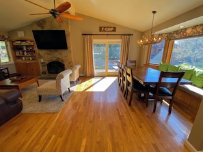 Living/Dining Area: Beautiful open concept space with large dining table that seats 10 and modern, comfortable furniture that surrounds the impressive stone fireplace.