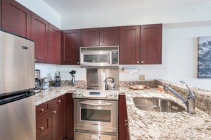 Kitchen with sinks, oven, and refrigerator.