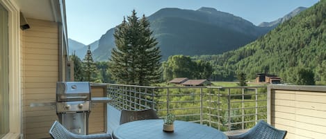 Deck outside of this Telluride Mountain rental with grill and seating.