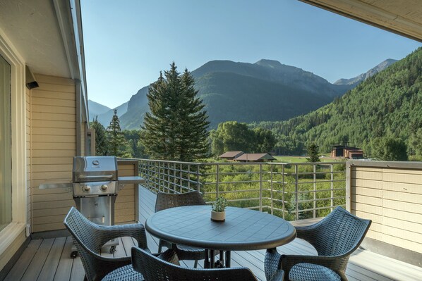 Deck outside of this Telluride Mountain rental with grill and seating.