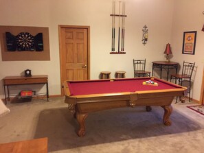 Pool table and electric dart board.