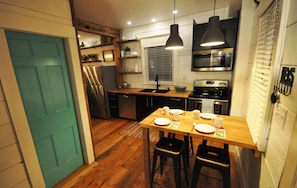 Modern kitchen with rustic shelving and flooring 