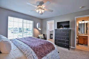 Master bedroom with queen bed, walk in closet and smart TV