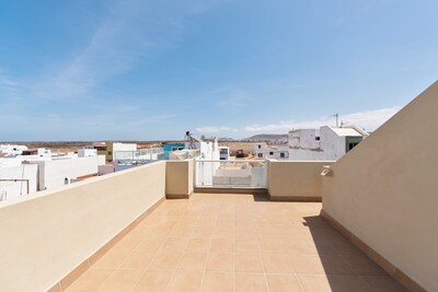 Town center and 200m to Beach. Private Patio and Shared Rooftop Terrace