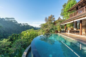 The pool flows seamlessly into the surroundings of the villa