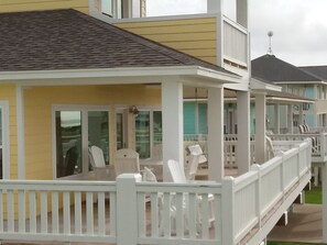 Front deck w/dining table and 4 chairs, 4 tall Adirondack chairs w/tables, swing