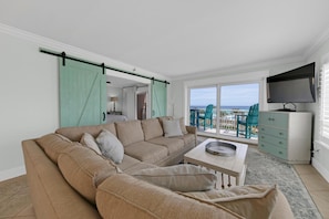 Beautiful living room with plush furniture and amazing beach views!