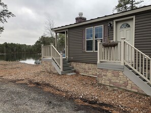 Home-sits directly on the lake parking on the side of home 