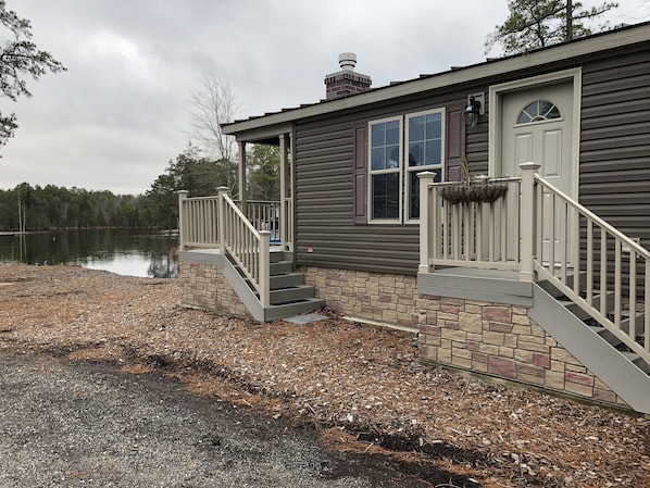 Home-sits directly on the lake parking on the side of home
