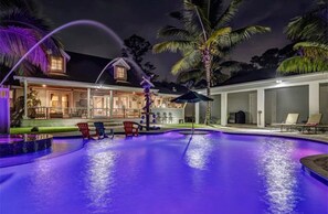 Resort style pool at night with led lighting.  Pool is full sun with no cage.  