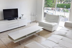 Nicely appointed living room with seating area and flat screen TV