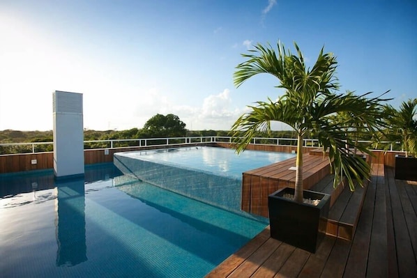 Roof top infinity pool with views to Cozumel