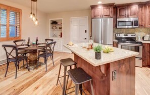 Renovated, fully-equipped kitchen (plus  bar seating) and dining room table.