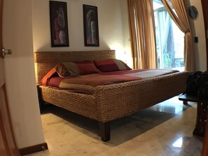 Master bedroom with king bed and balcony.