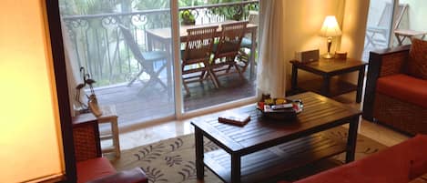 Living Area and Large Balcony overlooking pool and gardens.