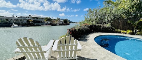 Slip into island time with a waterfront backyard and a water edge pool! Aloha!