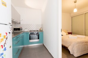 Colorful kitchen and bedroom in Tel Aviv apartment 