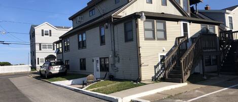 Lower unit - Car parked right next to unit - Background house is beachfront