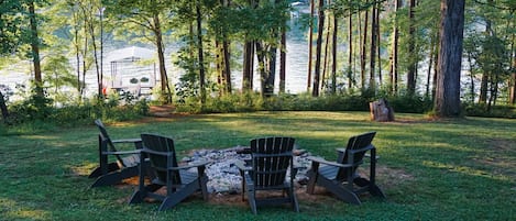 Quiet lake front home with private dock and backyard fire pit.