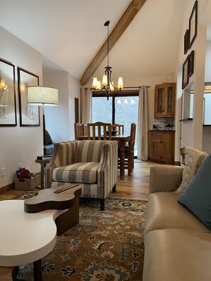 Dining table for six is positioned between the family room and kitchen.