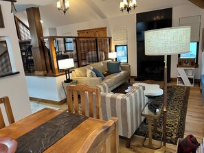 The game room, slightly perched above  family room allows the kids their space