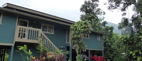 Front of house showing two of the parking spaces under house 