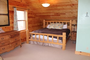 King sized log bed in upstairs master bedroom