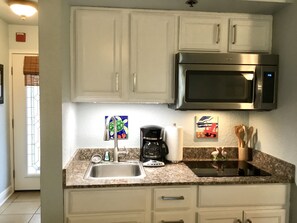 Kitchen with stovetop and microwave 