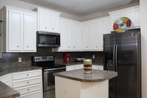 Kitchen with new stove, microwave & frig