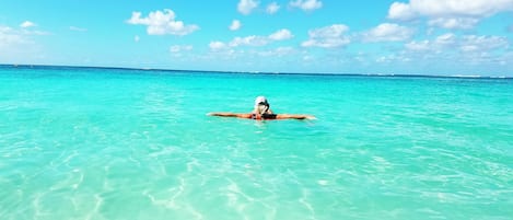 Relax in the crystal clear warm water on Seven Mile Beach, Grand Cayman