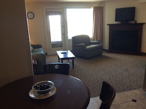 View from kitchen table through to living room and deck door.