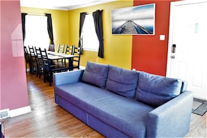 Living Room / Dining Room with fold out couch and 4K TV