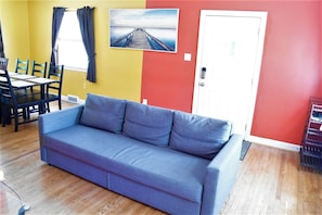Living Room / Dining Room with fold out couch and 4K TV