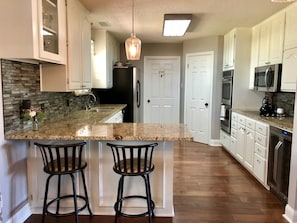 Large, well stocked kitchen with open floor plan