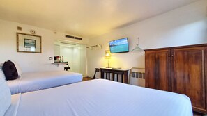 2 Queen Size comfortable beds with plush pillows in a studio