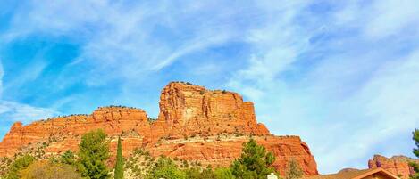 View of our home & garage with red rock overhead.