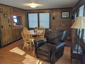 Dining table in back living room with pass through to kitchen.