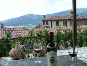 A nice glass of wine next to the pool with a magnificent view of Cortona