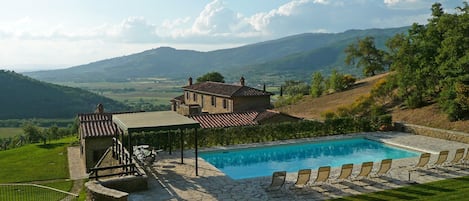 Pool, house, & garden with Tuscan farms below & medieval town of Cortona.