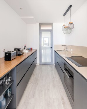 Kitchen equipped with oven, microwave, dishwasher, toaster, capsule coffe maker