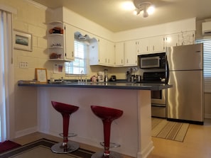 Fully furnished, spacious kitchen has upscale stainless steel appliances