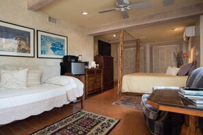 Comfortable queen bed, bamboo sheets, smaller twin day bed, kitchenette and TV.